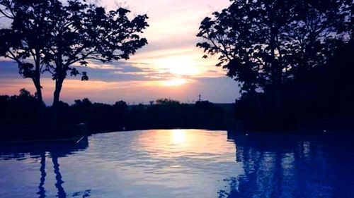 Scenic view of lake against sky during sunset