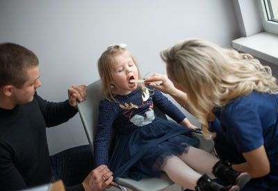 Female doctor examining girl