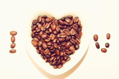 High angle view of coffee beans on white background