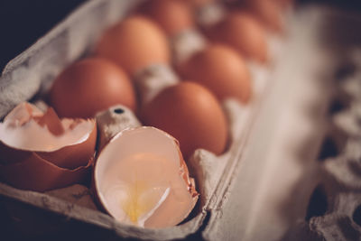 Close-up of cracked eggs in carton