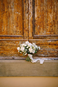 Close-up of white flowering plant on wooden door