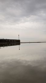 Pier over lake against sky