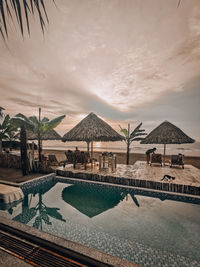 View of swimming pool at sunset