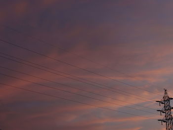 Low angle view of electricity pylon against sky