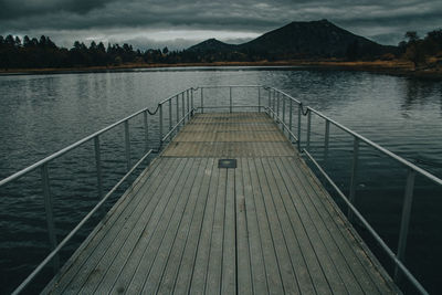 Pier over lake against sky