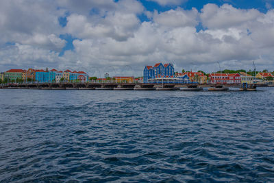 Scenic view of sea against sky in city