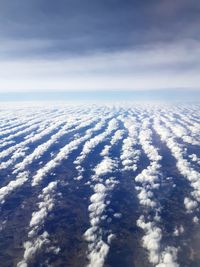 Aerial view of clouds over sea against sky