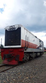 Train on railroad track against sky