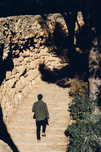 Rear view of man moving up on steps