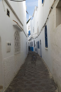 Empty alley amidst buildings in city