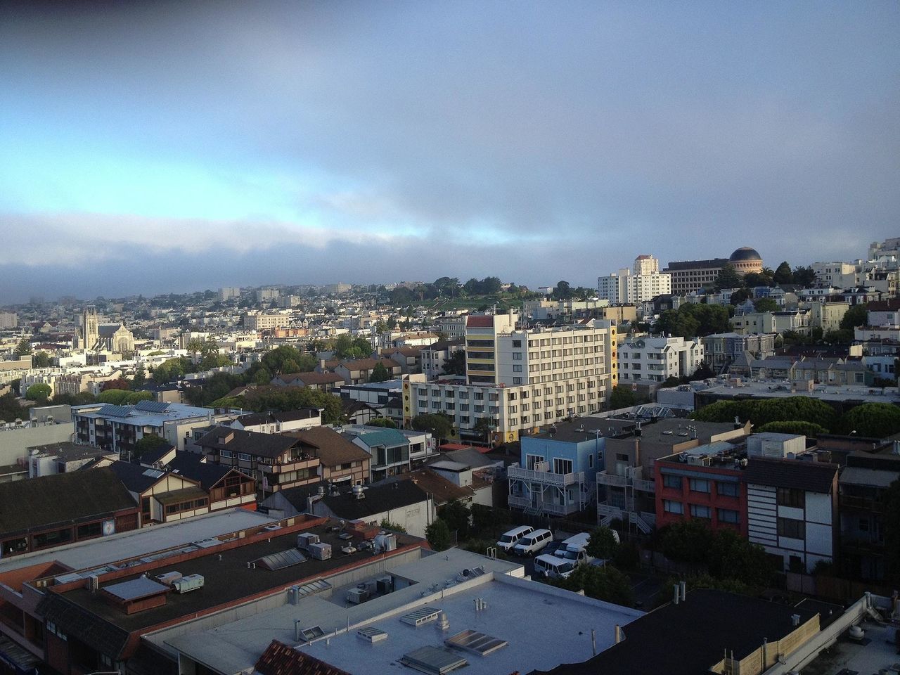 building exterior, architecture, cityscape, built structure, city, crowded, high angle view, residential district, sky, residential building, residential structure, cloud - sky, city life, house, community, aerial view, townscape, outdoors, town, human settlement