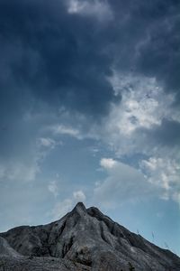 Low angle view of volcanic mountain against sky