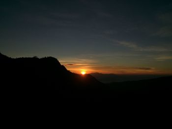 Scenic view of silhouette mountains against sky during sunset