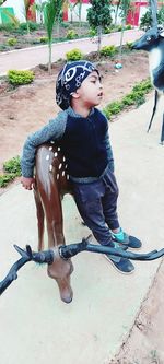 Woman looking away while sitting outdoors