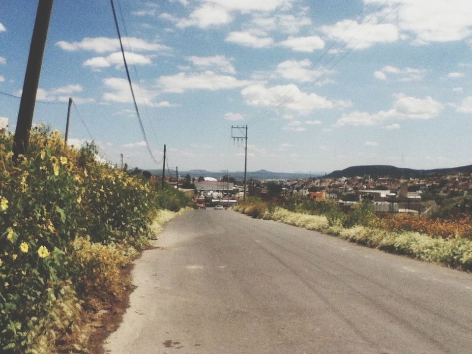 the way forward, sky, road, transportation, electricity pylon, power line, diminishing perspective, vanishing point, cloud - sky, street, cloud, electricity, country road, building exterior, tree, empty road, day, landscape, outdoors, built structure