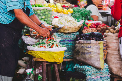 Midsection of man selling food for sale