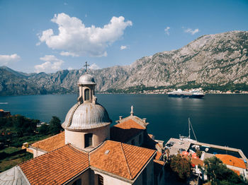 Scenic view of sea and mountains against sky