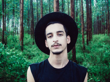 Portrait of young man in forest