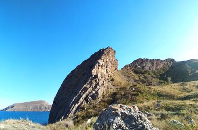 Scenic view of mountains against clear blue sky