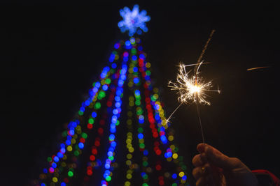 Low angle view of firework display at night