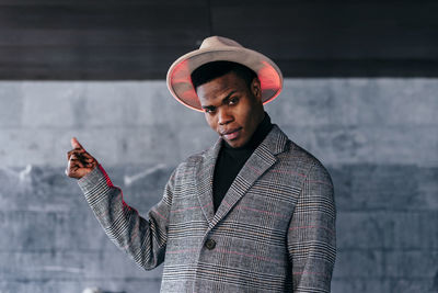 Portrait of young man standing on mobile phone