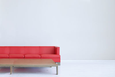 Empty sofa against white wall at home