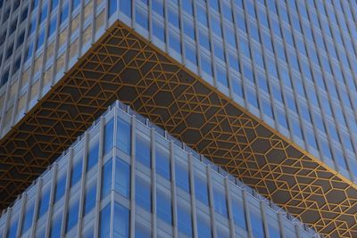 Low angle view of modern building against blue sky