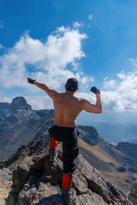 Rear view of man standing on rock