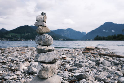 Stone pyramid in front of lake and mountains