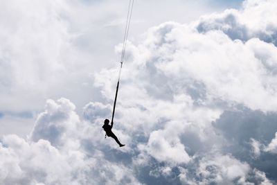 Low angle view of bird flying against sky