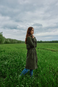 Side view of woman standing on field