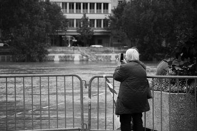 Rear view of woman taking picture