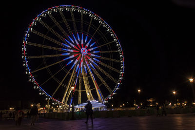 Illuminated ferris wheel at night