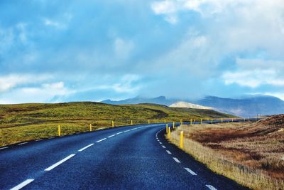 Empty road along countryside landscape