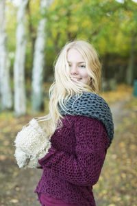 Portrait of happy teenage girl in winter wear outdoors