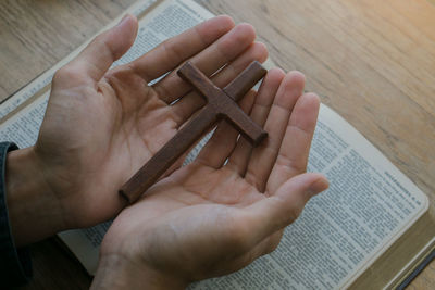 High angle view of hand holding book