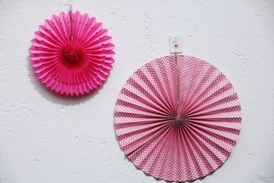 Close-up of hand fans hanging on wall