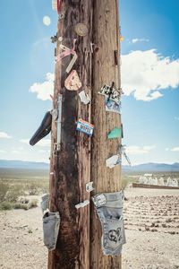 Papers and signs on wooden post at nevada desert