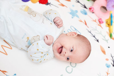 Cute baby looking away lying on bed