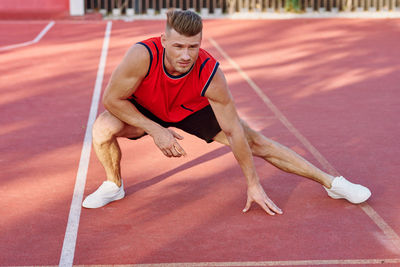 Full length of man exercising on field