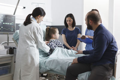 Doctor and nurse examining patient at hospital