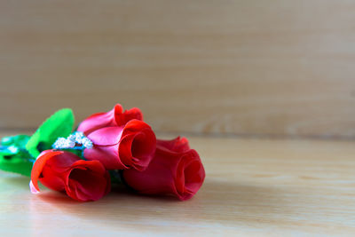 Close-up of red rose on table