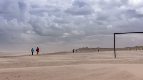 People on beach against sky