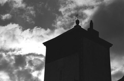 Low angle view of silhouette building against sky