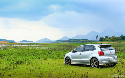 Car on field against sky