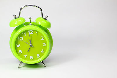 Close-up of clock over white background