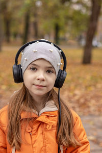 Portrait of young woman wearing hat standing outdoors