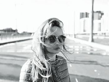 Portrait of young woman looking at water