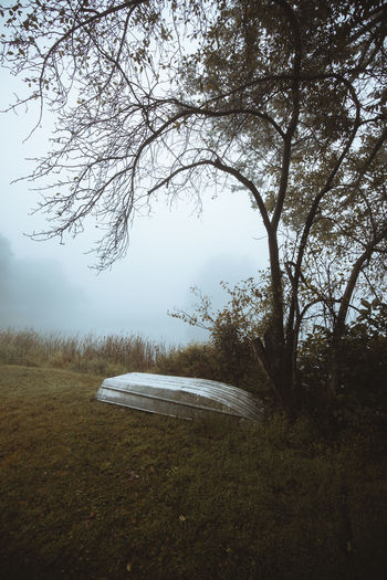 Boat on lake against sky during foggy weather