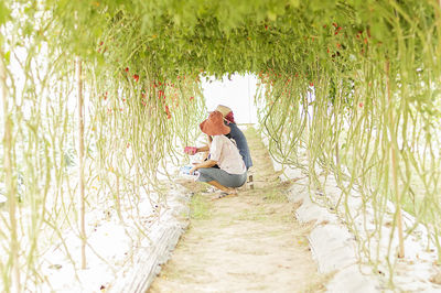 Side view of a man sitting on landscape